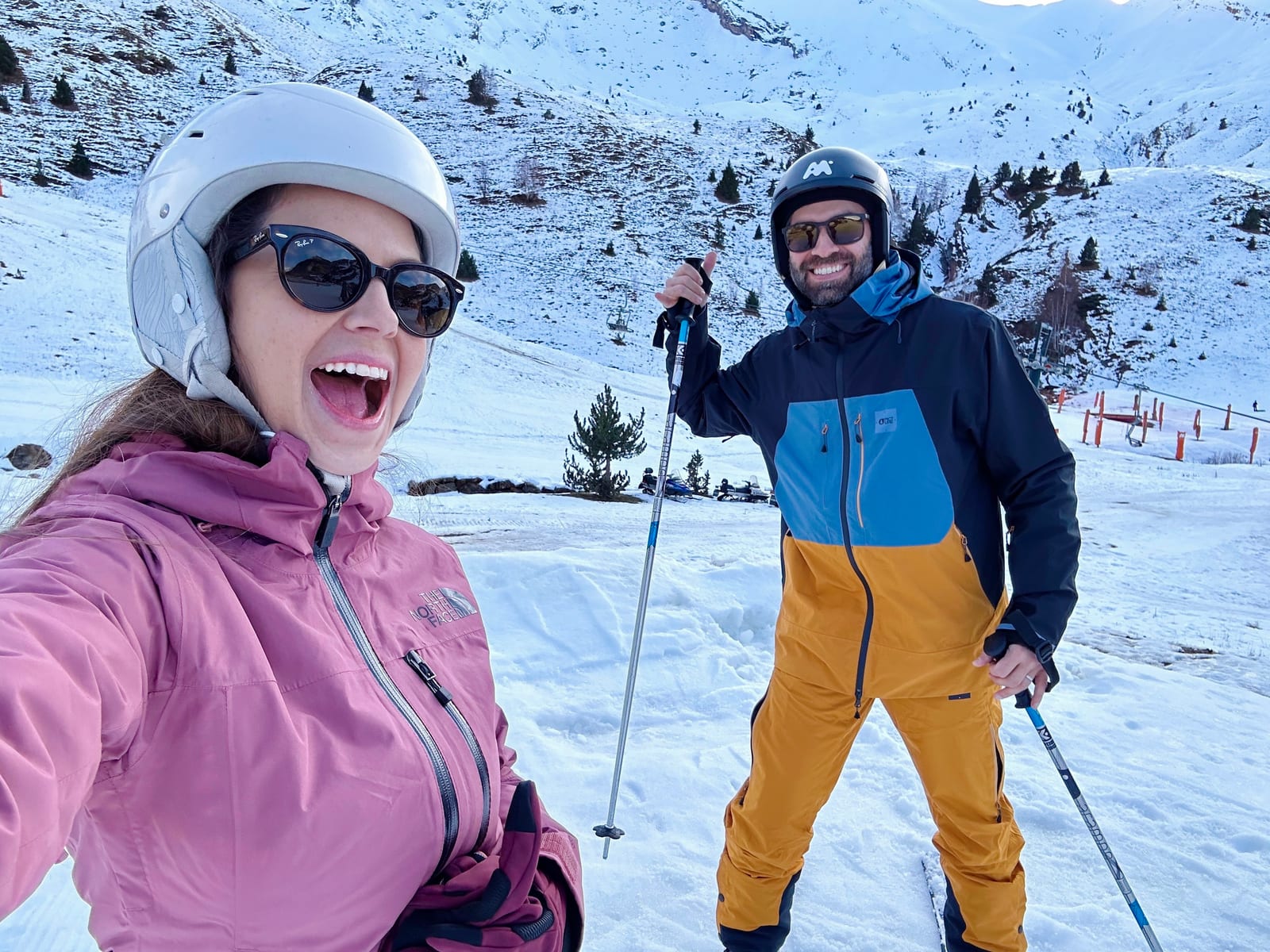 Pablo and wife in ski gear in snowy mountains